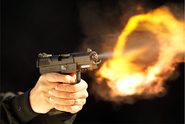 Almost unseen by the naked eye, a flash fire appears after firing the FN Five-seveN single-action semi-automatic pistol.