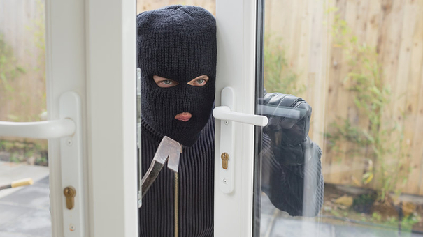 Burglar opening the door with crobar